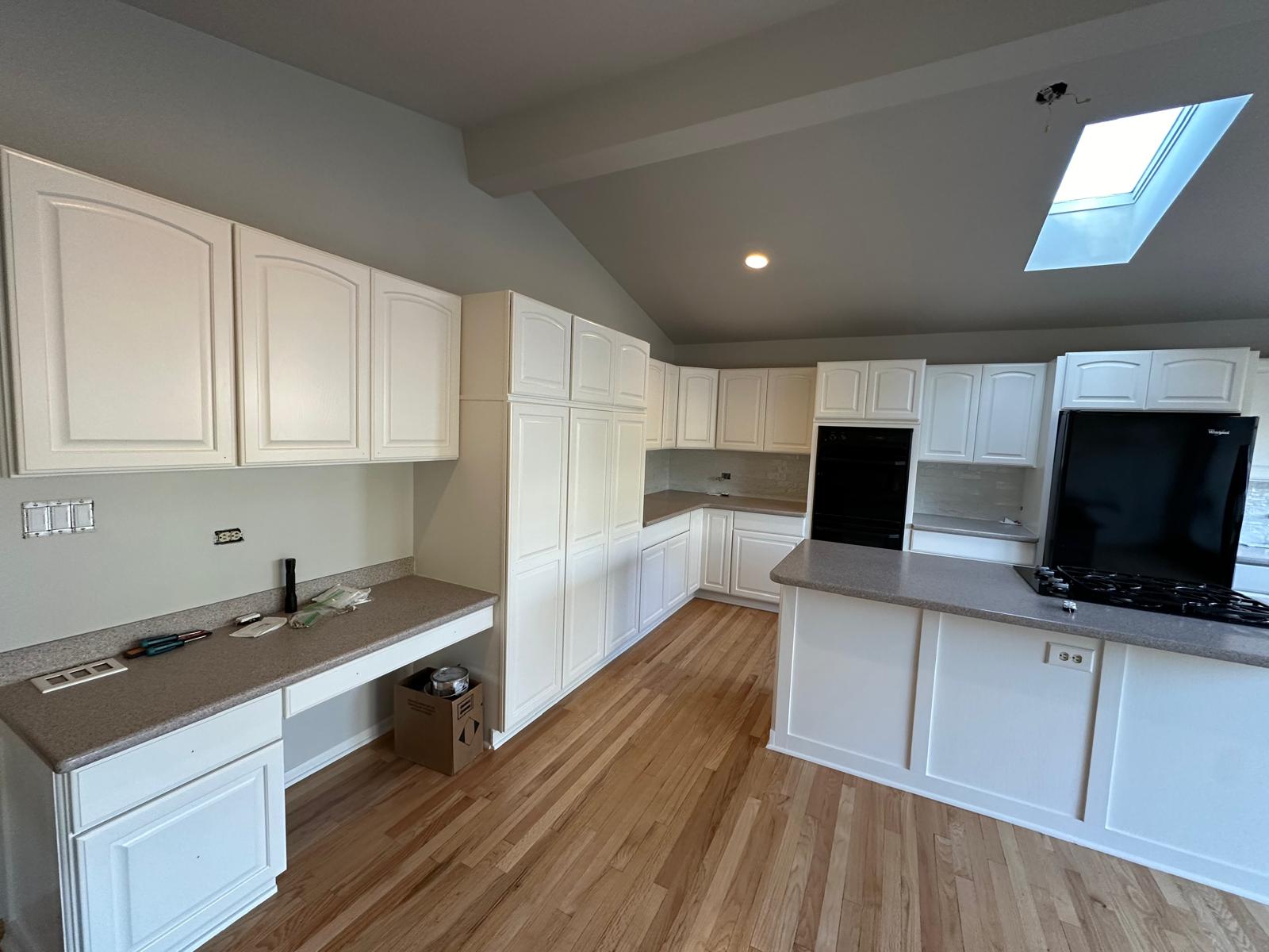 Kitchen cabinet refinishing with skylight