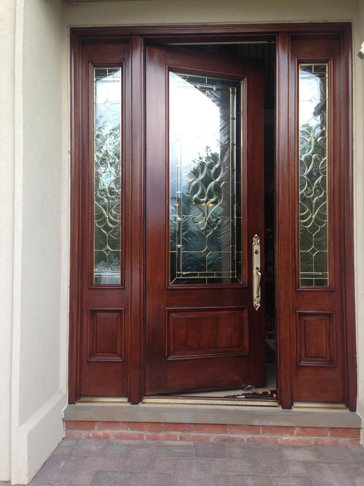 Beautifully stained front entry door with stone arch