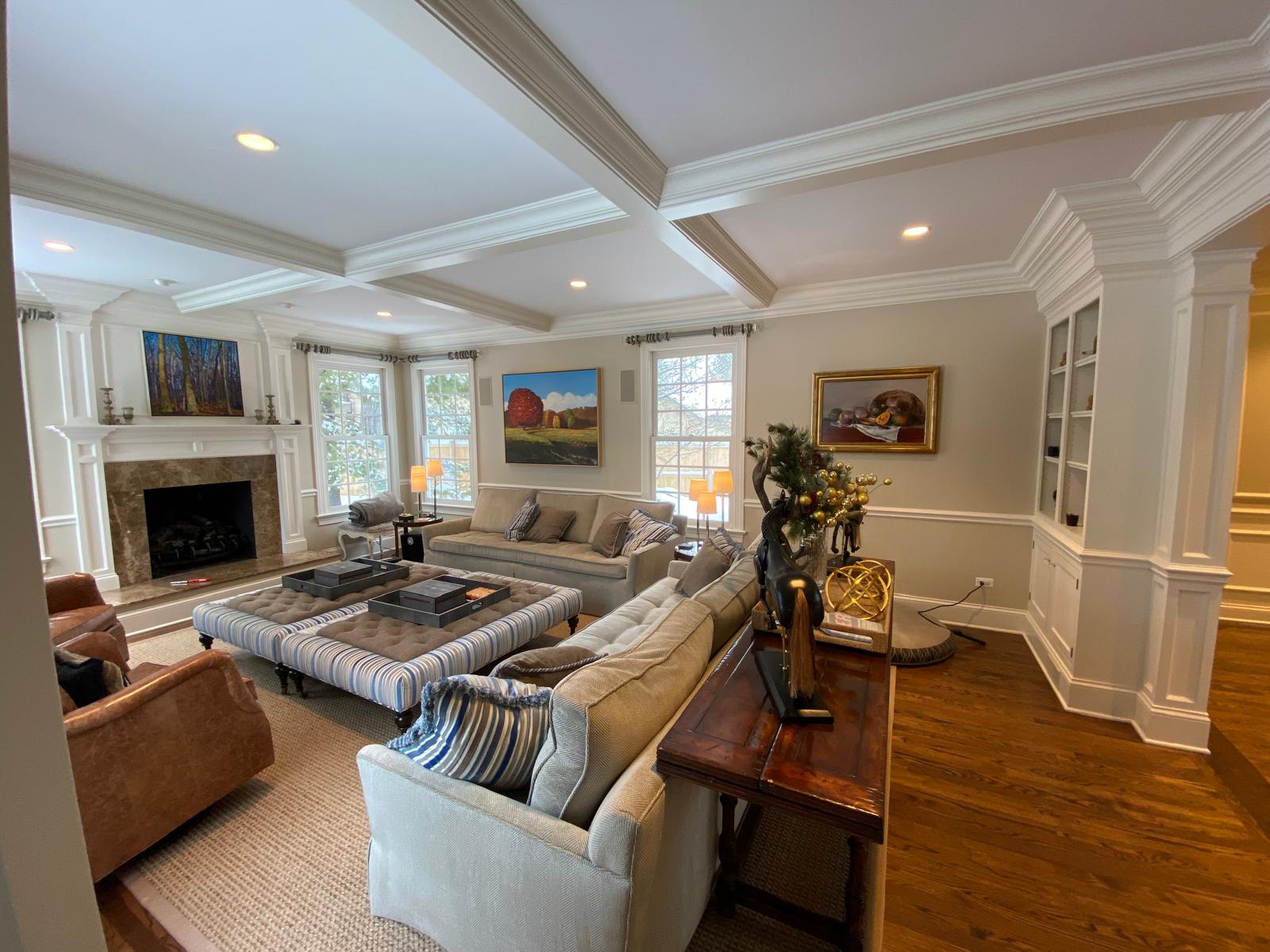 Grand staircase with wainscoting and trim work by TPT Decorating